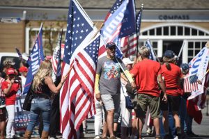 Trump supporters await the motorcade of Donald Trump near a campaign fundraiser event at billionaire Tom Seibel's home in Woodside, CA. One supporter wears a shirt of Donald Trump that says "Chillin like a Felon" (Photo Credit: Genie Sullivan, September 13, 2024).